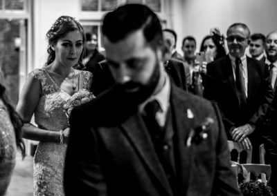 black and white photograph of bride walking up the aisle at the Bluecoat in Liverpool