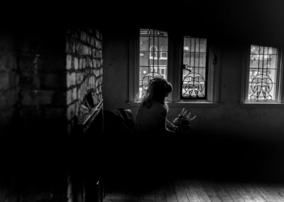 silhouette of bride sitting on chair at Victoria Baths in Manchester