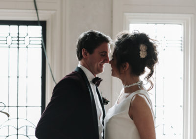 documentary photograph of a smiling bride and groom at Victoria Baths in Manchester